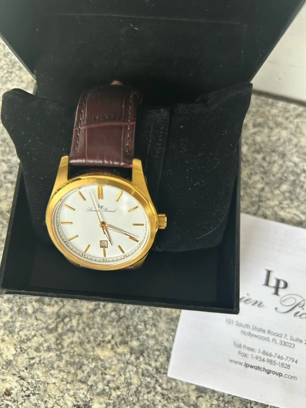 Lucien Piccard Gold Tone Case with Brown Strap and White Dial Accents